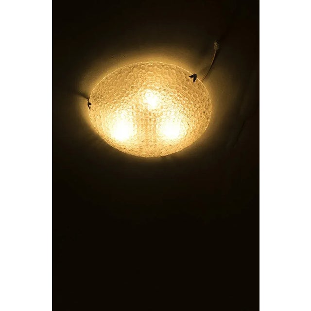 Beautifully shaped glass ceiling light with chrome details. In good vintage condition. Measurements H. 10,5 cm; Ø 51,5 cm....