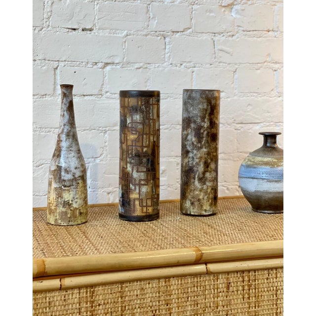 French ceramic vase by Alexandre Kostanda (circa 1960s). This beautiful cylindrical vessel presents a misty appearance...