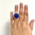 This is part of Chairish’s Fine Jewelry assortment. Gorgeous 21.75 ct. black lightning ridge opal round with 3.80 ct. of...