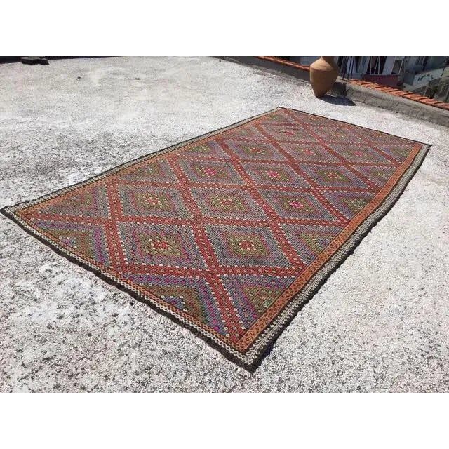 Beautiful, vintage, handwoven kilim is approximately 60 years old. It is handmade of very fine quality, hand-spun wool in...