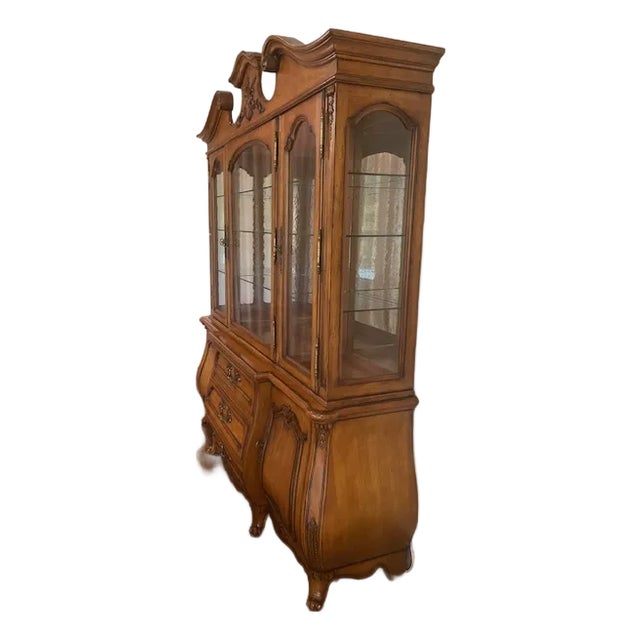 Classic craftsmanship, solid hardwood with fine veneers, 2 piece china cabinet. Upper lighted , mirror backed display...