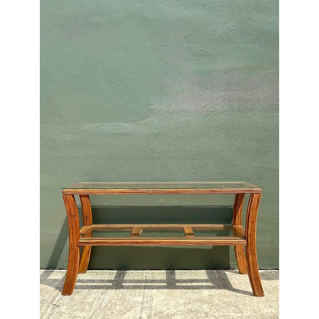 Elegant and effortlessly versatile, this vintage pencil reed and glass console table captures the relaxed sophistication...