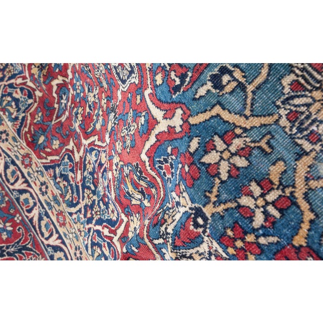 A hand-knotted wool antique Persian Kirman (Kerman) rug dating back to circa 1930. The main filed contains alternating...