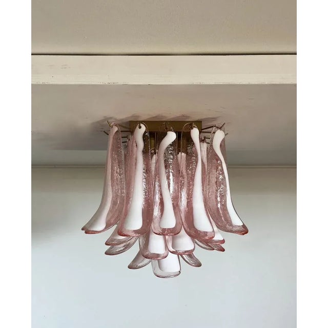 Spectacular ceiling lamp with 32 Murano pink glass petals (pink with white spot) in golden painted metal frame. Elegant...
