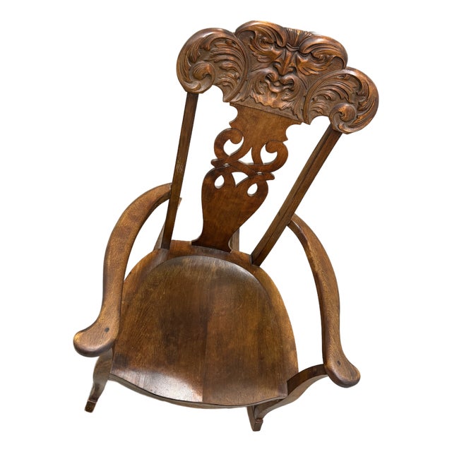 Late 19th Century German Carved Wooden Rocking Chair Featuring a "Man Blowing the Wind" Motif. For Sale