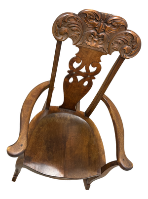 Late 19th Century German Carved Wooden Rocking Chair Featuring a "Man Blowing the Wind" Motif.