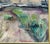 Vintage impressionist oil painting showing a river bank in muted tones with a tree branch extending out to the water. Bold...
