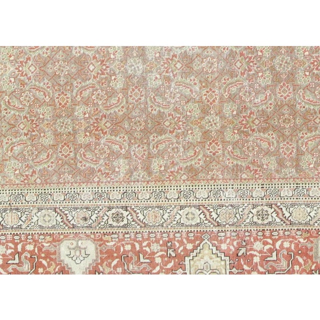1960s Persian Tabriz Rug. Hand woven in the Tabriz region of Northern Iran. Distressed and refinished in the U.S. The...