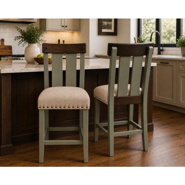 Set of two counter height stools in Old Chapel Sagewood™ with natural wood accents and neutral upholstered seats. Features...