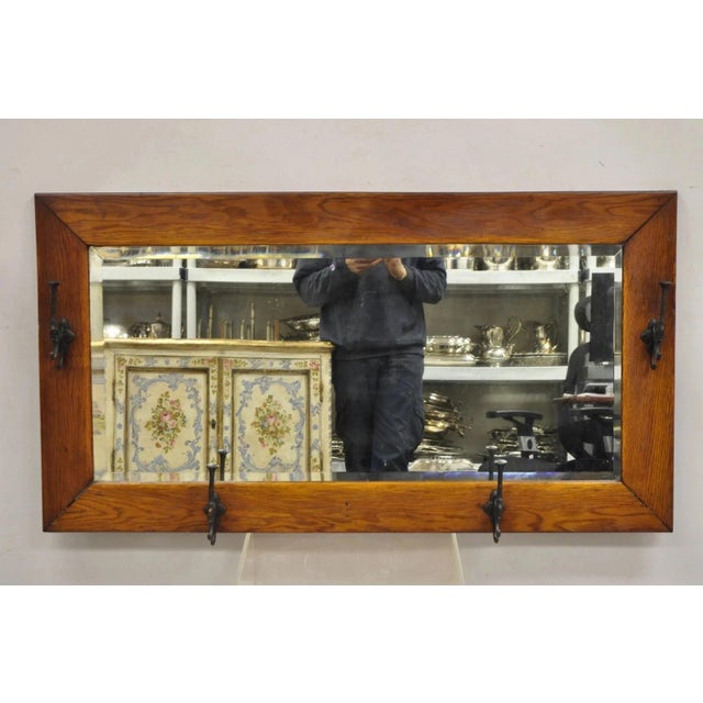 Antique Arts & Crafts Mission Oak Wood Beveled Glass Hall Mirror Iron Coat Hooks. Circa Late 19th Century. Measurements:...