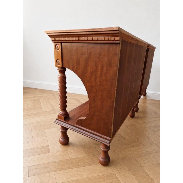A refined pair of bedside tables (or nightstands) crafted from solid mahogany with a mahogany crotch veneer, featuring a...