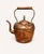 A beautifully aged antique copper teapot or kettle featuring a classic rounded form and richly textured hand-worked...