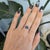 A 2.63-carat blue star sapphire displays a soft six-rayed star across its domed cabochon, set in solid 14K white gold with...
