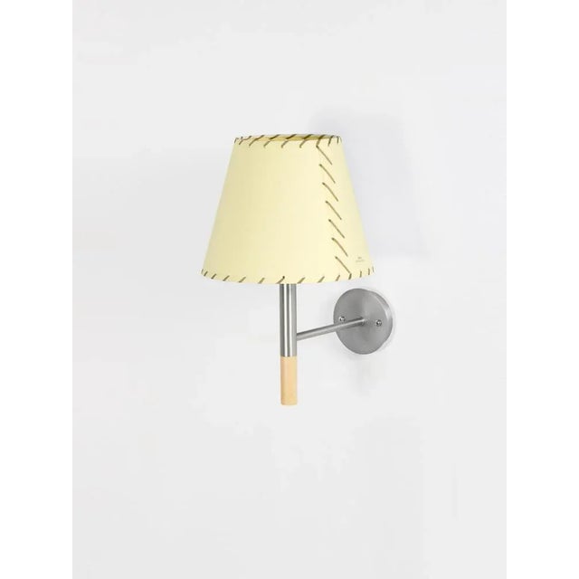 Beige bc2 wall lamp by santa & cole dimensions: d 20 x w 26 x h 33 cm materials: metal, beech wood, stitched parchment....