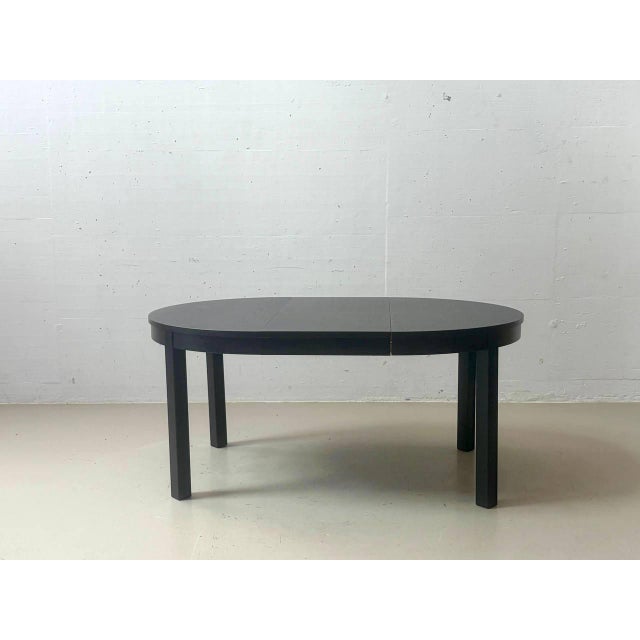 Extendable bjursta dining table from ikea in black-brown with a simple, scandinavian design. When closed, the table has a...
