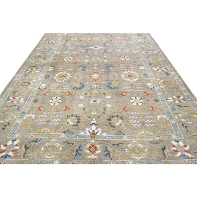 Beautiful modern Sultanabad hand-knotted wool rug with a light brown field. This Sultanabad rug has multicolor accents in...