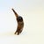 A vintage elephant figurine made out of a piece of carved and polished cow horn. Natural curved shape. Measures 2"W x...