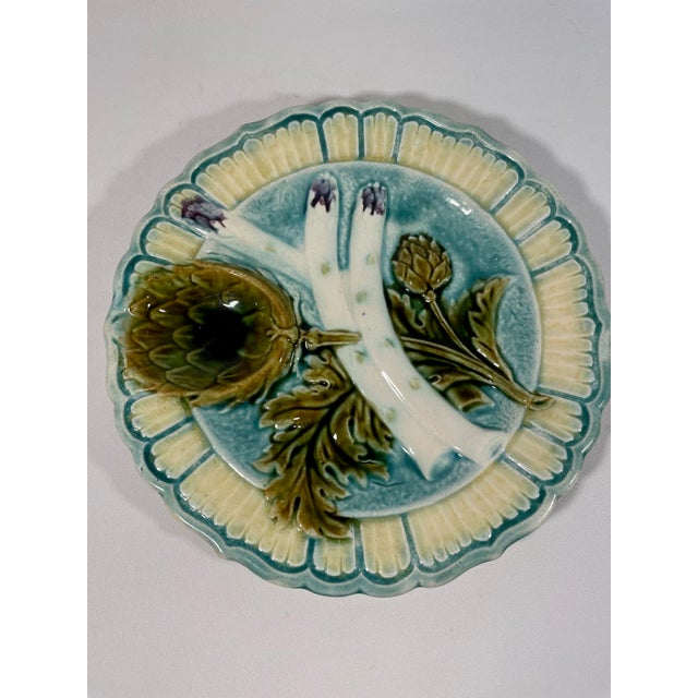 A charming ceramic French Majolica Asparagus Plate with a decorative artichoke sauce compartment. Circa 1880-1890s. Made...