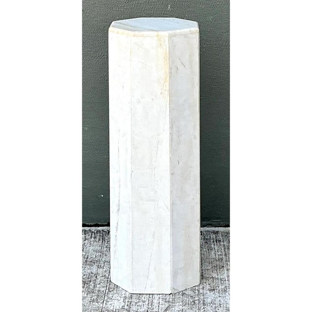 This vintage hexagonal pedestal presents a clean, architectural silhouette, rising as a slender, faceted column with...