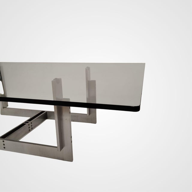 The "Floarian" table designed by Carlo Scarpa in 1973 features a satin-finish steel base and a clear glass top. Dimensions...