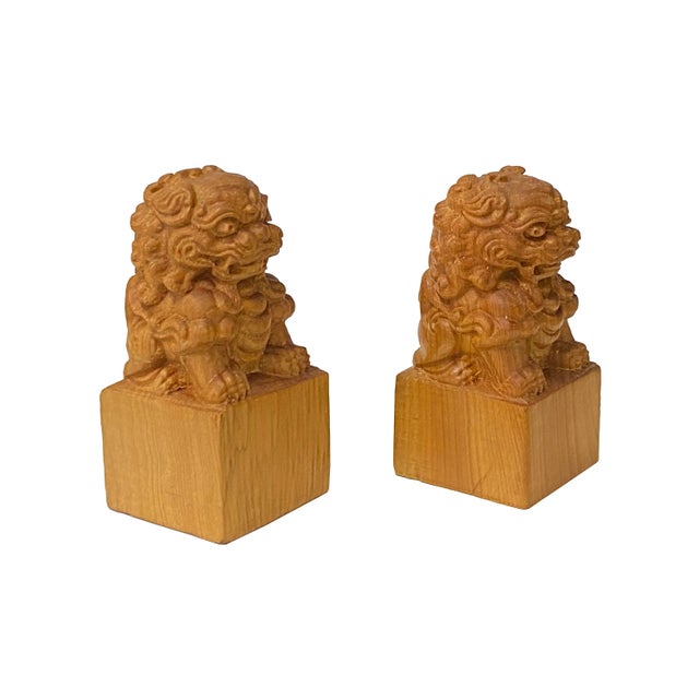 This is a pair of wood-carved mythical Foo Dogs Fengshui Lions Figures in mini size with a smooth polished surface....