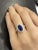 This vintage, retro, Art Deco-style ring features a GIA Certified 2.38-carat oval cut blue sapphire of Cambodian origin...