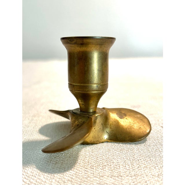A distinctive pair of brass candlestick holders designed in the form of marine boat propellers, produced by Andrea by...