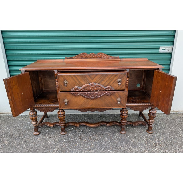 Stunning vintage / antique sideboard buffet in what appears to be walnut with geometric veneer details. Carved details on...