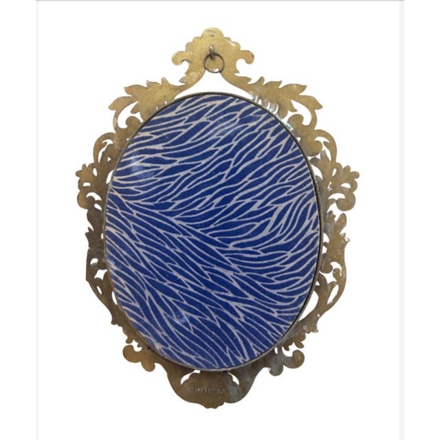 Mid-century ornate mirror to hang on wall. It has a little ring for hanging. Please see matching decorative bowl in my...