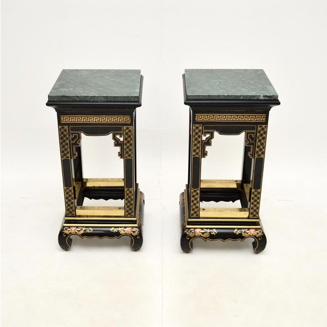 A stunning pair of antique lacquered chinoiserie marble top side tables. They were likely made in England in the oriental...