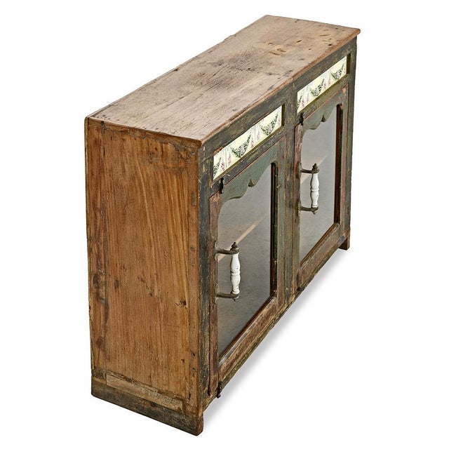This small weathered wooden sideboard is a truly exceptional piece for lovers of old furniture and authentic decoration....