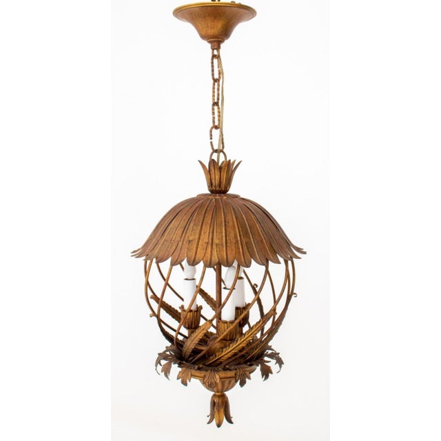 Italian Gilt Patinated Metal Rustic Style Openwork Lantern, 1970s, with a leaf form bell-shaped canopy above a diagonal...