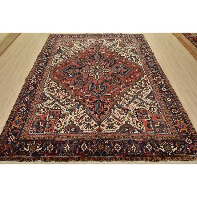An authentic vintage traditional tribal Heriz rug hand-knotted with fine wool and natural dyes. This nomadic rug features...