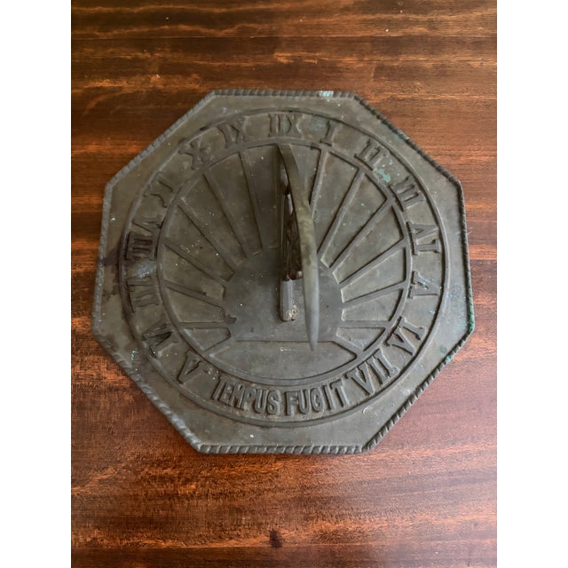 A stunning vintage iron garden sundial reading "Tempus Fugit," which translated from Latin means "Time Flies." USA, Late...