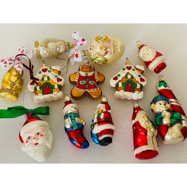 Dozen of blown glass Handpainted Christmas ornaments, including Gingerbread, Santa’s and Snowman.