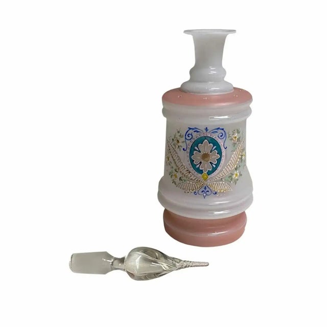 A beautiful 19th century opaline hand painted decanter in pale pink and white with a swirled crystal stopper. Center...