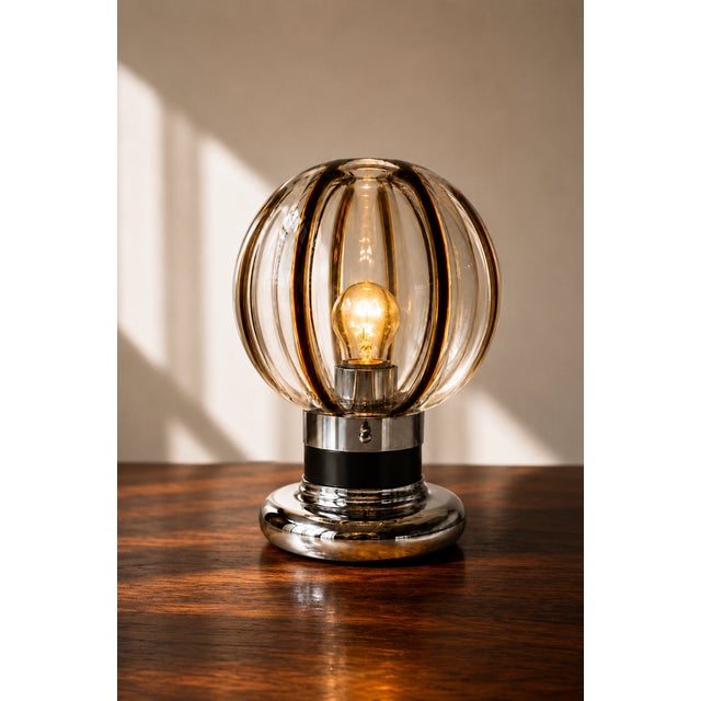 A touch of exceptional rarity introduces this stunning and imposing space age mid century modern table lamp attributed to...