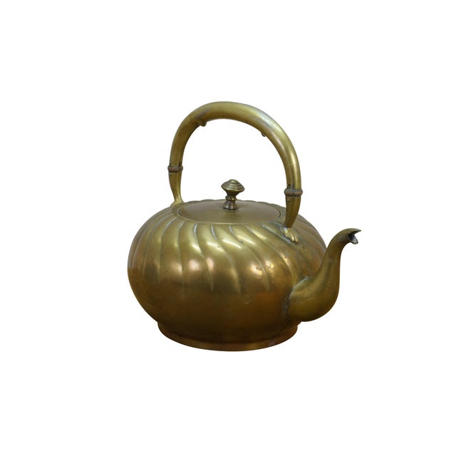 Antique Art Nouveau secessionist brass teapot with a swirled repoussé design. Produced circa 1900 during the late...