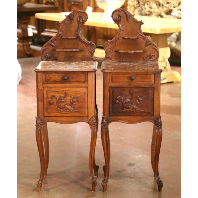 Graceful proportions and charming Rococo details give this elegant pair of antique bedside tables exceptional French...