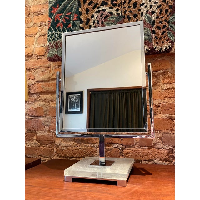 A fabulous tiltable double-sided vanity mirror in lucite and chrome, designed by Charles Hollis Jones. Heavy and very...