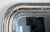 An authentic Louis Philippe mirror featuring a carved wood frame and curved top corners. This item was sourced directly...
