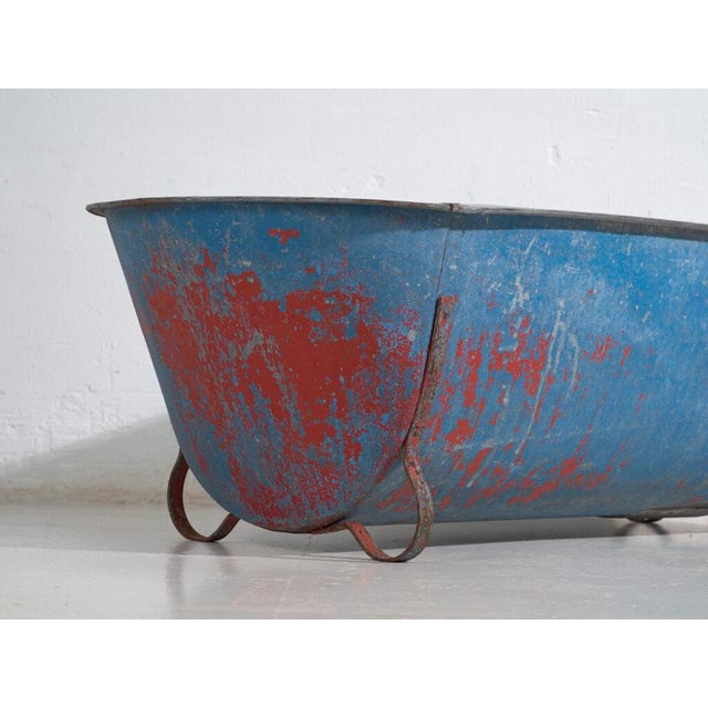 Antique galvanized zinc bathtub with iron structure, originating from Central Europe, circa 1900.This type of metal tub...