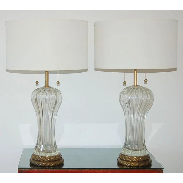 Classic Murano glass lamps by Marbro on brass colored wreath bases. The glass is CRYSTAL CLEAR, thick and vertically...