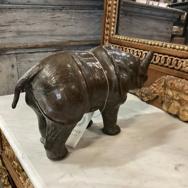 A hollow leather folk art rhinoceros figure from India. This vintage animal molding has a beautiful sheen and patina, and...
