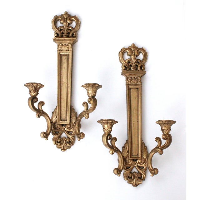 Pair of ornate gilded French double-arm candle sconces. Made of lightweight Syroco. Includes wall mounting hardware. WE...