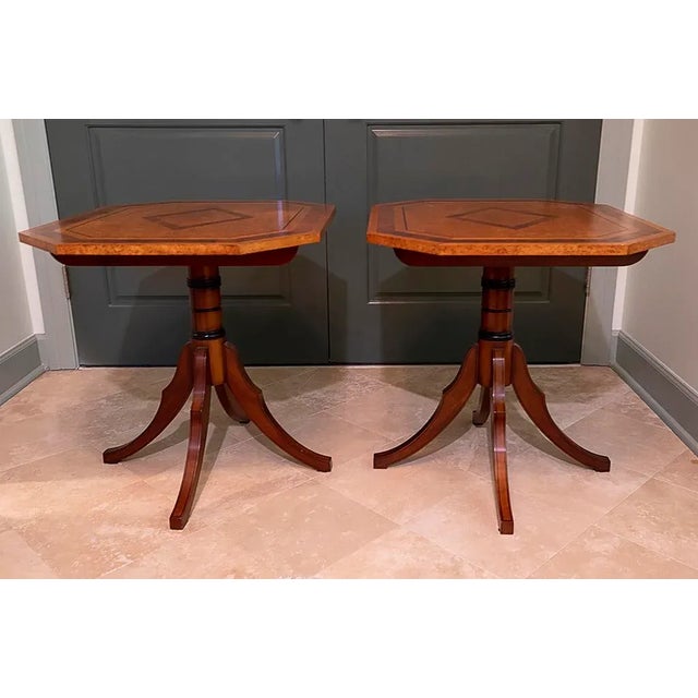 Large tables on elegant black trimmed pedestal bases with geometric marquetry inlays on the tops. Quality American...