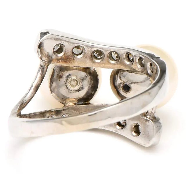 A fabulous pair of Akoya pearls are surrounded by lines of sparkling diamonds in this uniquely designed bypass ring. The...