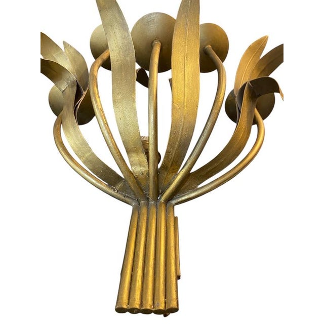 This light fixture is typical of the Hollywood Regency style with a strong Italian Florentine/mid-century influence....