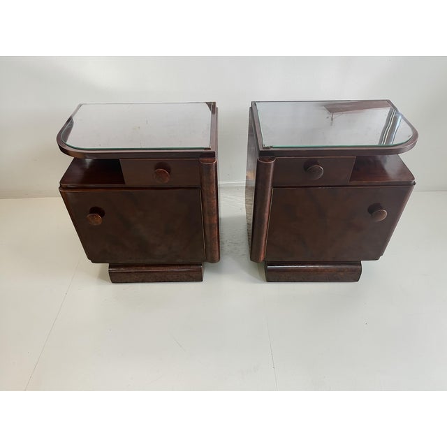 This elegant pair of Art Deco bedside tables dates from the late 1930s to early 1940s and showcases the refined...