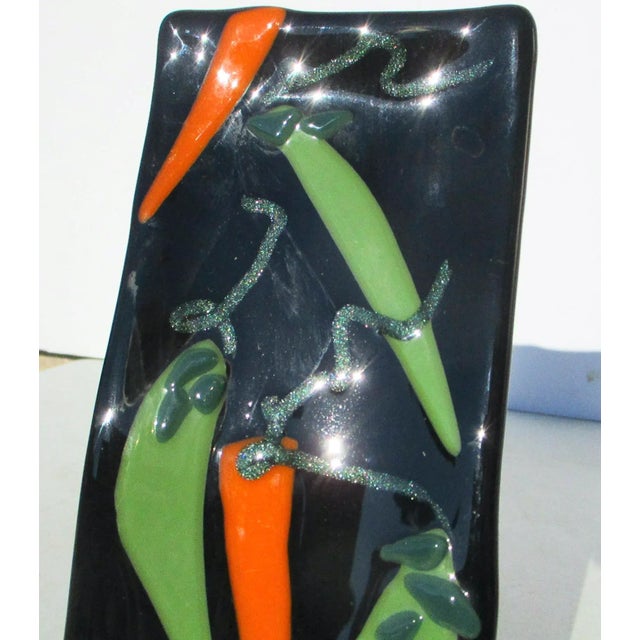 Fused glass pieces formed to make this pattern of peppers and vines on a wavey black glass tray. A very lively and bright...
